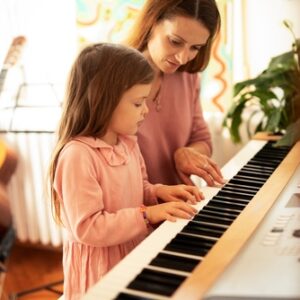 Parent encourageant son enfant pour enseigner la musique le piano la guitare